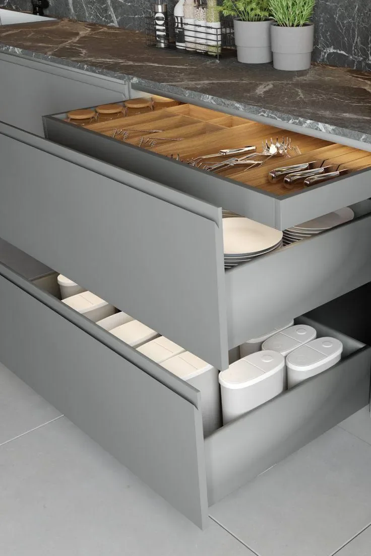 Open kitchen drawers with a wooden cutlery organiser